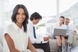 © WavebreakmediaMicro - Smiling businesswoman with work colleagues