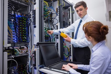 Poster - Team of technicians using digital cable analyser on servers