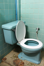 Closeup Of Green Flush Toilet, Lid Open.