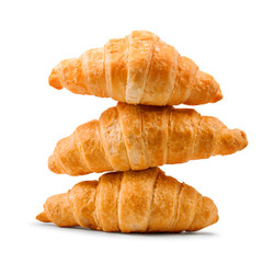 pile of fresh and delicious croissants on a white background