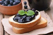Toasted Bread With Blueberry Jam On Wooden Table