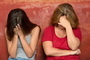 Wall Mural - Teenage girl and her mother crying after a fight