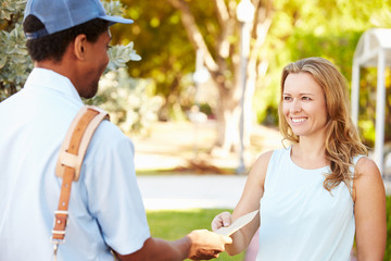 mailman delivering letters to woman