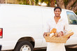 Baker Delivering Bread Standing In Front Of Van