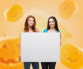 Wall Mural - smiling teenage girls with white board