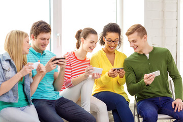 Sticker - smiling students with smartphone texting at school