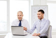 © Syda Productions - two smiling businessmen with laptop in office