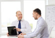© Syda Productions - two smiling businessmen with laptop in office