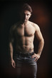 © theartofphoto - Handsome shirtless muscular man on dark background