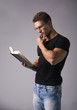 © theartofphoto - Handsome Sexy Muscular Man Reading Big Book on Grey