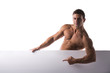 © theartofphoto - Strong muscular shirtless young man holding a white banner