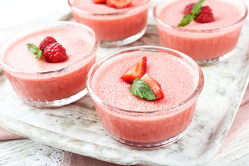 Wall Mural - Delicious berry mousse in bowls on table close-up