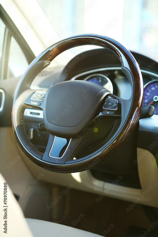 Interior view of car with beige salon and black dashboard