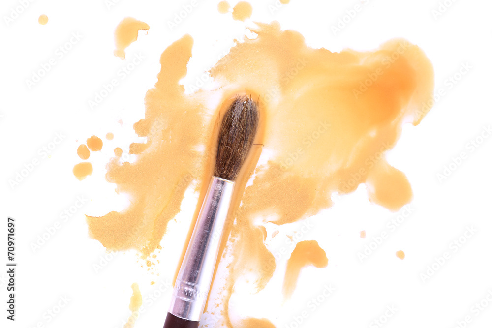 Brush and spilled paint isolated on white