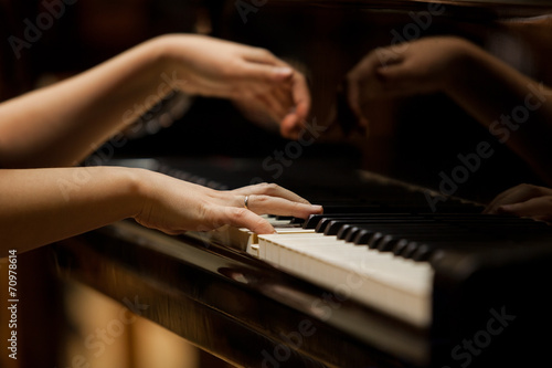Fotografie, Obraz Woman's hands on the keyboard of the piano closeup