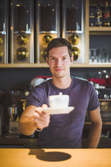 Waiter holding coffee cup