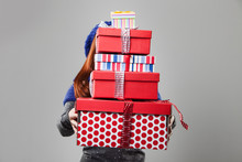 Woman Covered By Carried Gift Boxes