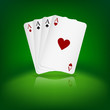 Four aces playing cards on green background.