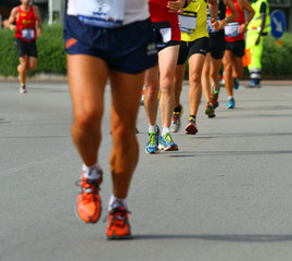 Wall Mural - legs of athletes engaged in long international marathon