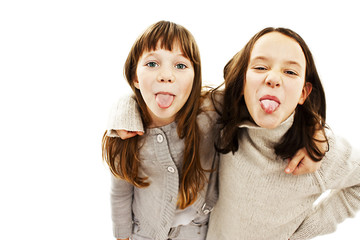 Two girls showing their tongues on white background