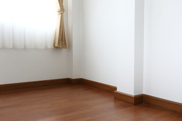 white mortar wall and wood floor in the room