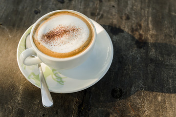 Wall Mural - Coffee cup on wooden table