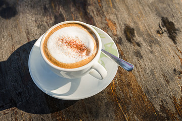 Wall Mural - Coffee cup on wooden table