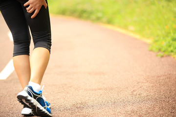 Canvas Print -  woman runner hold her sports injured leg