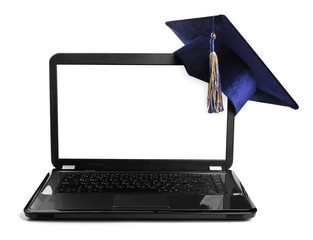 laptop with blank screen and education student cap