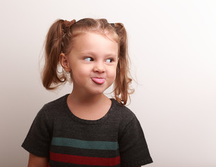 Fun kid girl showing the tongue with happy look