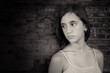 Black and white image of a depressed teenage girl