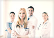 © Syda Productions - female doctor in front of medical group