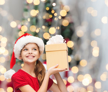 Smiling Girl In Santa Helper Hat With Gift Box