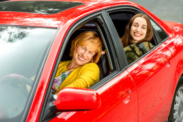 Mother with daughter in the red car