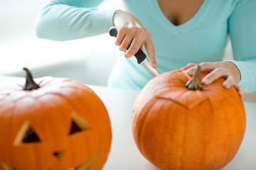 Wall Mural - close up of woman with pumpkins at home