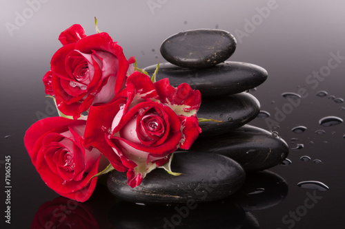 Fototapeta na wymiar Spa stone and rose flowers still life. Healthcare concept.