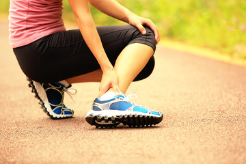 Poster -  woman runner hold her twisted ankle