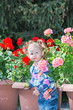 © vitmark - Adorable little child girl in park near flower Bed in summer