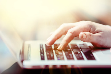 Female hands on laptop, close-up