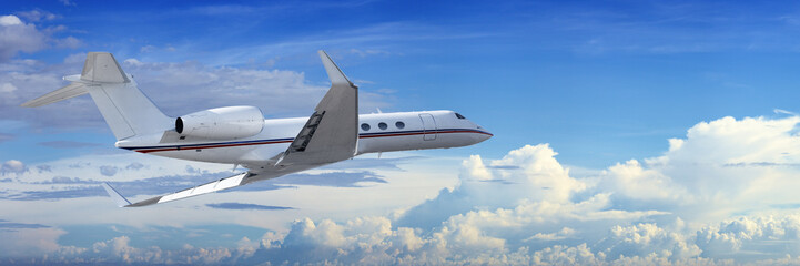 Fototapete - Corporate jet cruising in a cloudy sky