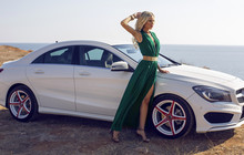 Beautiful Blond Woman Posing Beside A Luxury Car