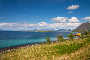 Wall Mural - scenic view of fjord, snow mountains and house, Norway, Lofoten