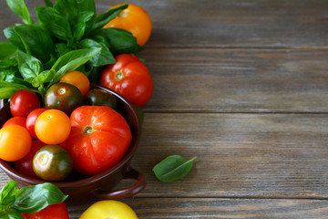 wooden background with tomatoes and basil