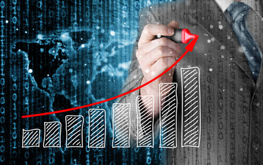 Business man drawing a growing graph