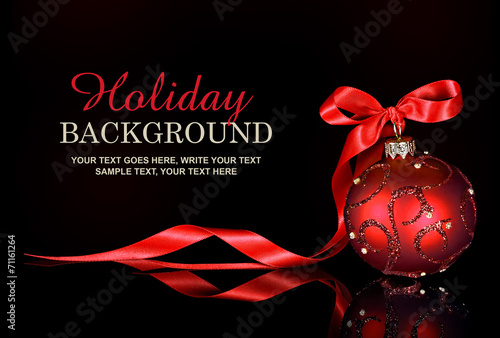 Fotografie, Obraz Christmas background with a red ornament and ribbon