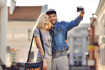 Couple taking self portrait photos with old camera