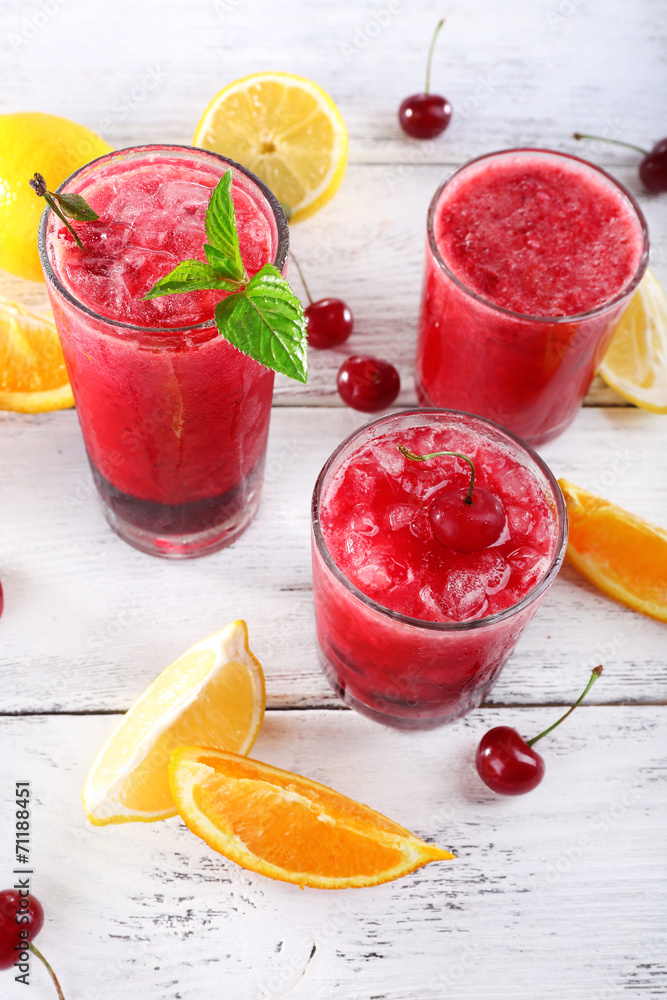 Fresh cold cherry cocktail with mint, ice and lemon