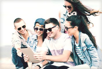 Wall Mural - group of teenagers looking at tablet pc