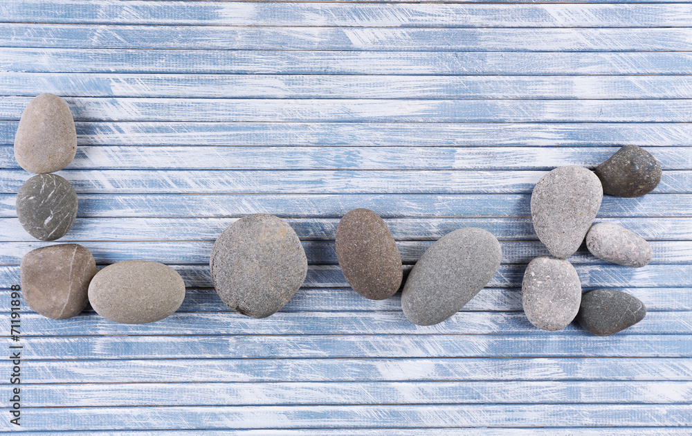 Love word formed with stoned on wooden background