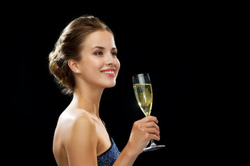 Canvas Print - smiling woman holding glass of sparkling wine